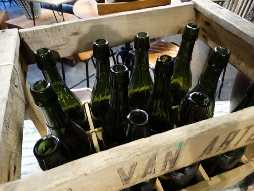 Green Glass Bottles in Wooden Crate Denver Furniture Store