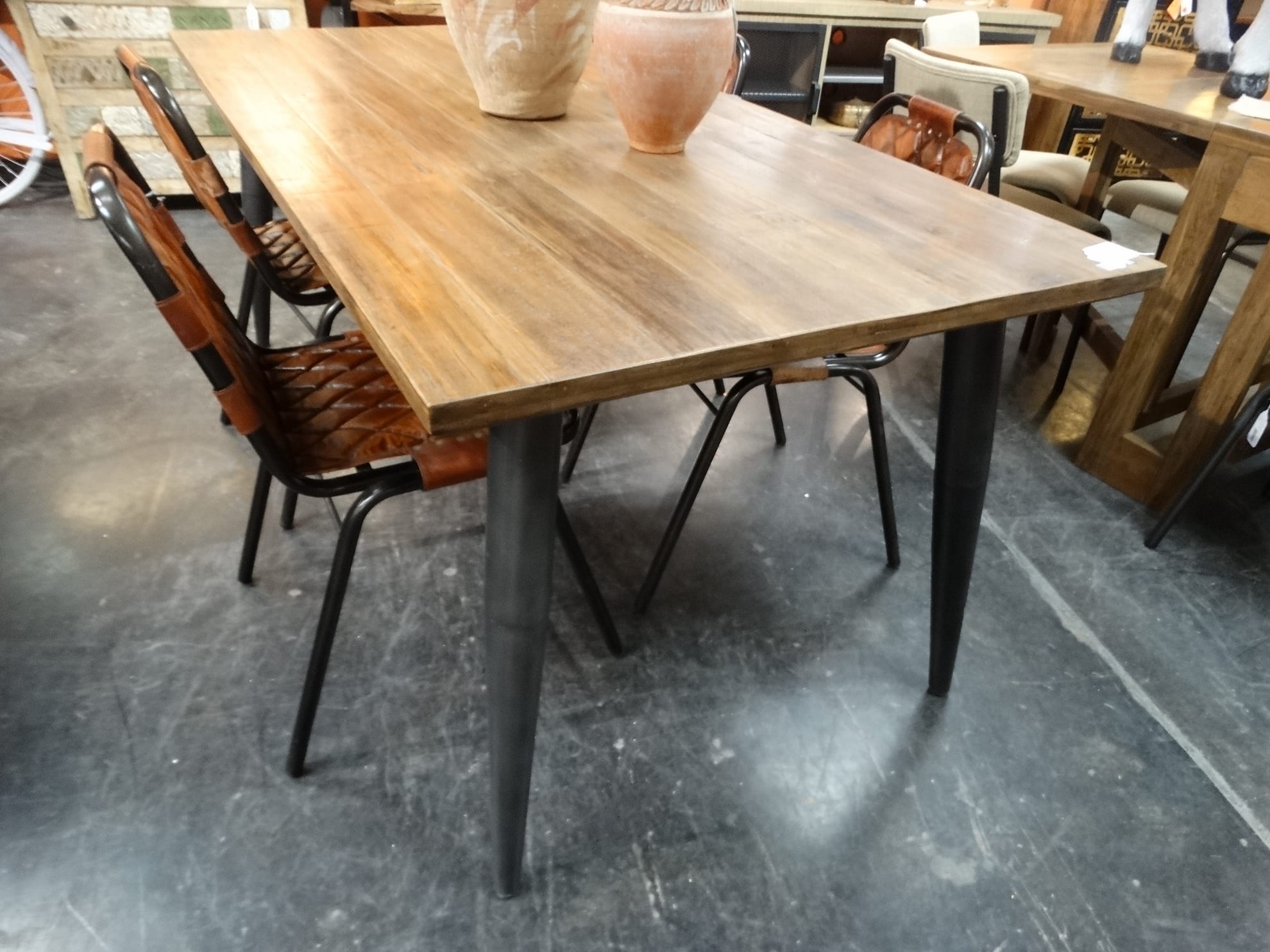 Wood And Iron Dining Table Features A Wood Top And Metal Legs
