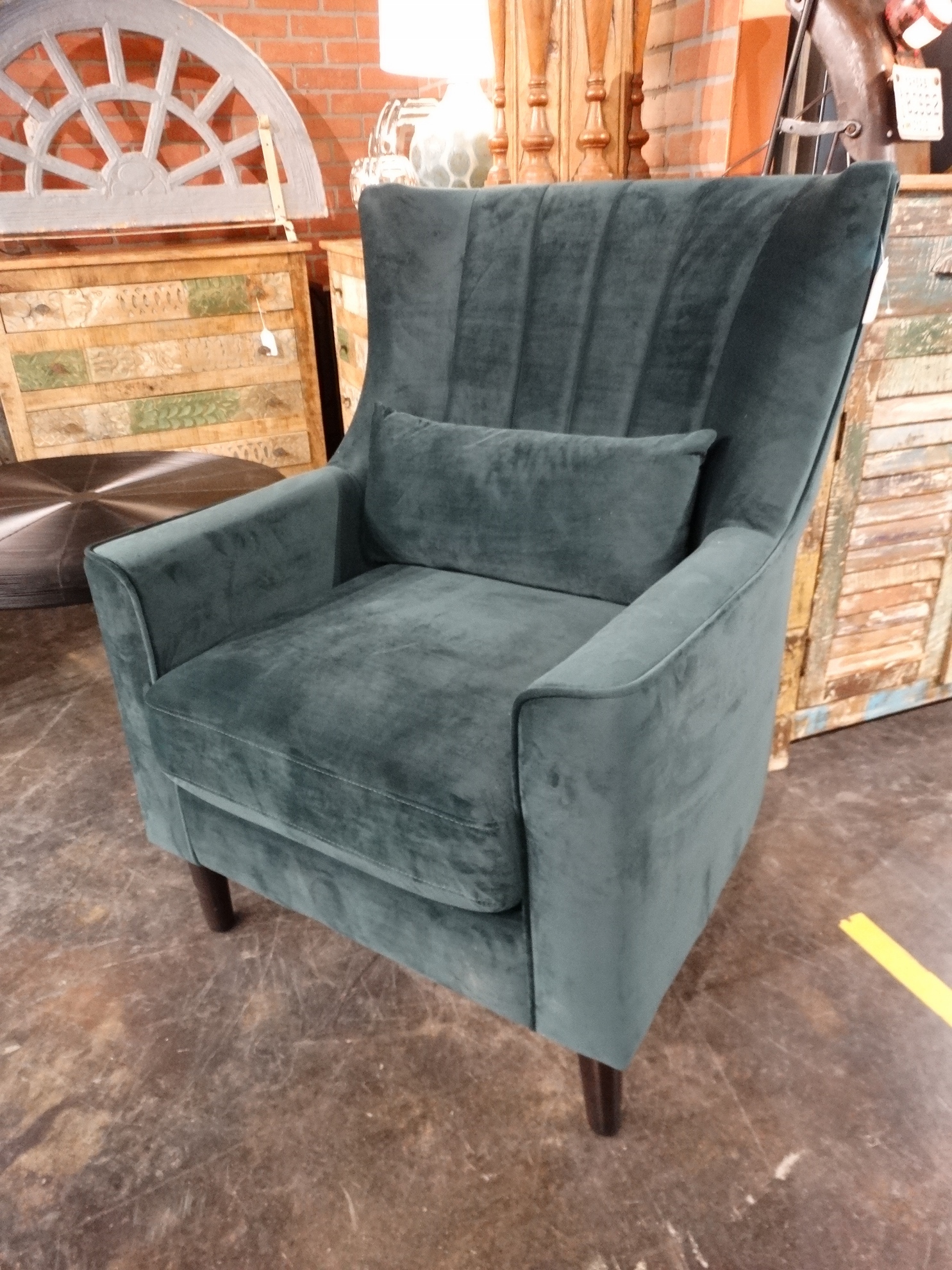 This green Upholstered Chair is soft and has a modern flair.