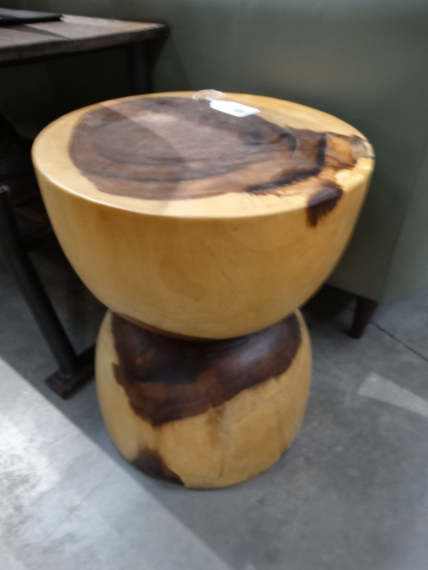 Wood Stump Side Table features an hourglass shape.