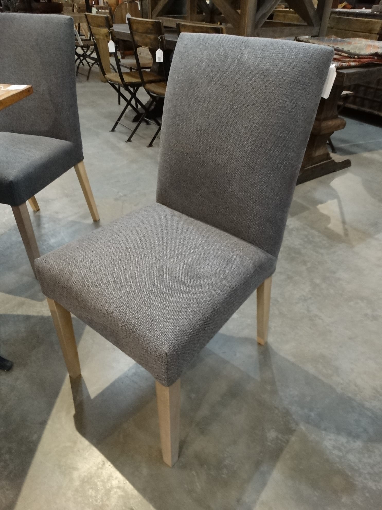 This grey linen side chair has a very modern flair with
