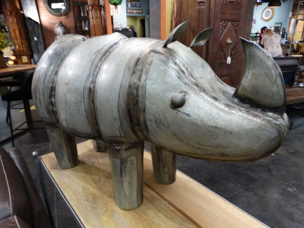 Decorative Rhino Statue has a horn and little ears and a tail.