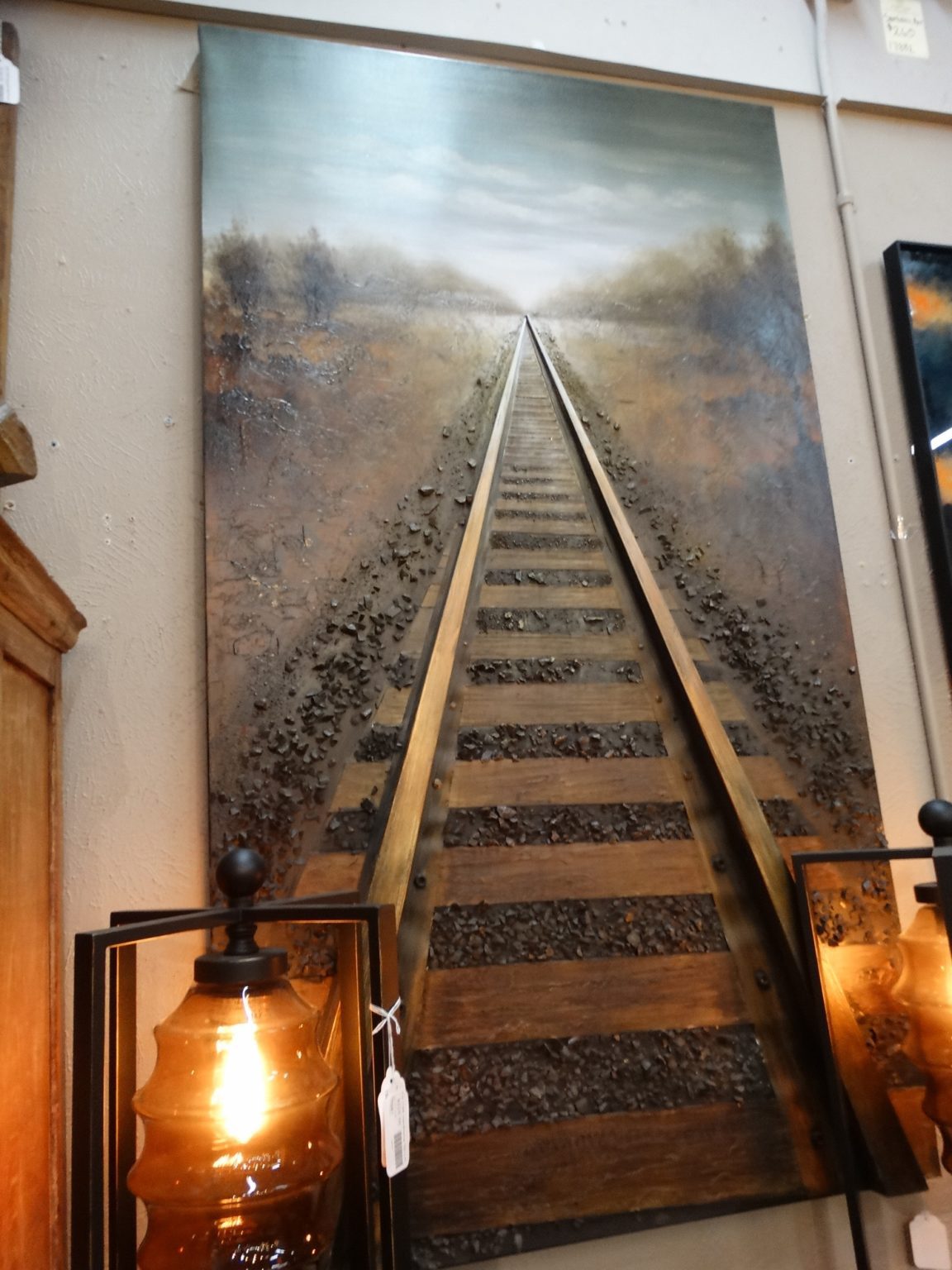 This wall art painting of train tracks going into the distance.